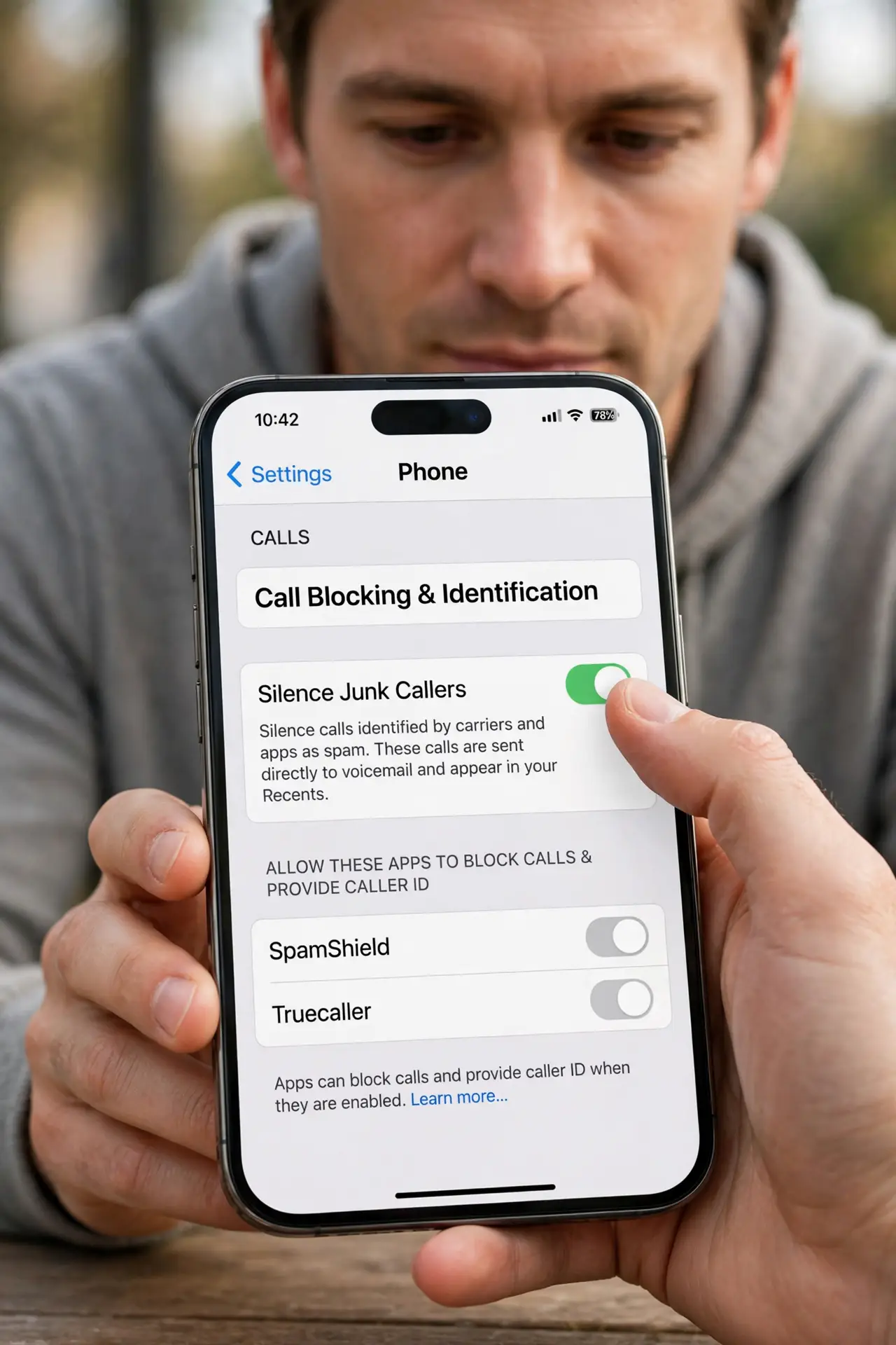 A person performing step 1: Turn on Silence Junk Callers.